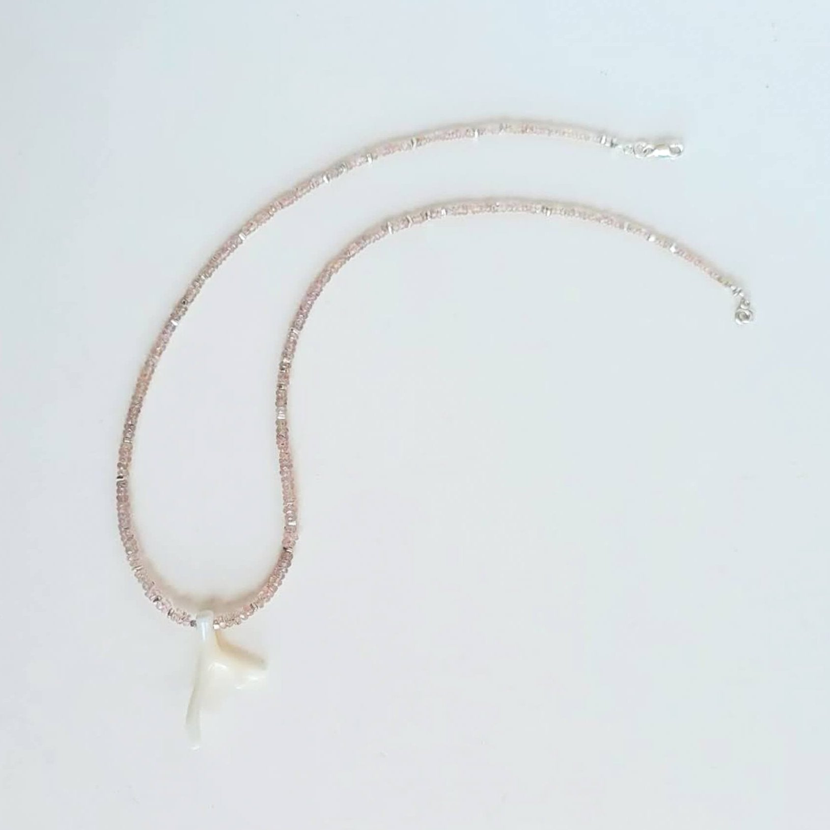 White Coral Branch on a Faceted Peach Sapphire Bead Strand