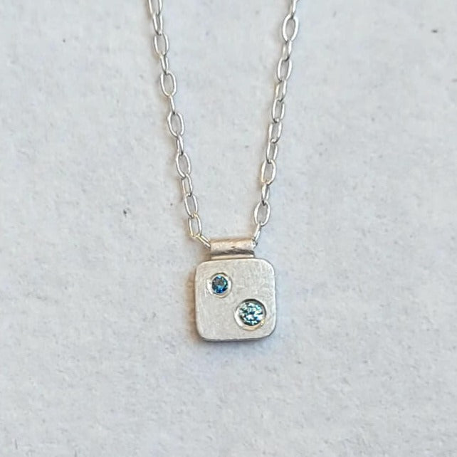 Sterling silver pendant necklace with blue diamond accents. Handmade by EC Design Jewelry in Minneapolis, MN.